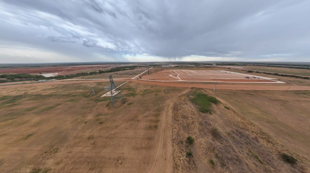 Aerial of the graded building pad beside transmission infrastructure, Hall County campus, August 28, 2026